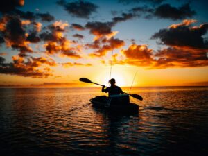 Kayaker paddling at sunset on the Gulf Coast
