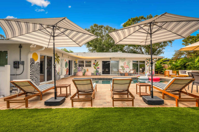 Courtyard with the pool and loungers at On the Creek