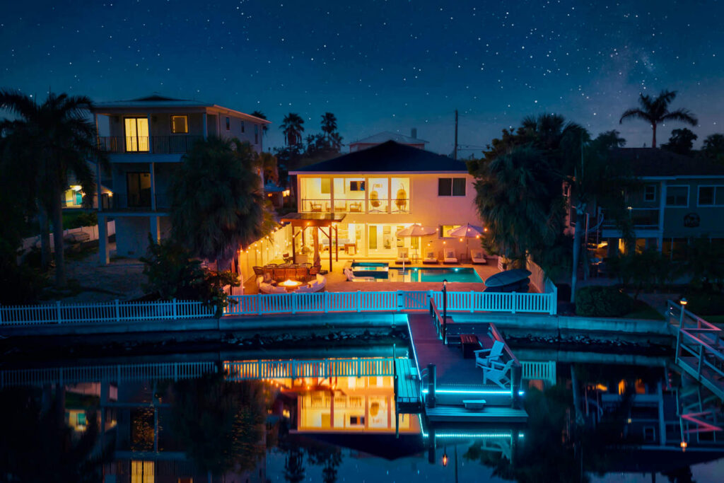 The home lit up at night across the water at Casa Blue Horizon