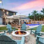 Fire pit and Adirondack chairs at sunset at Seminole Sands