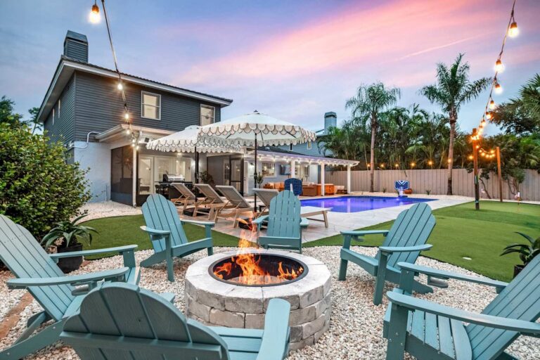 Fire pit and Adirondack chairs at sunset at Seminole Sands