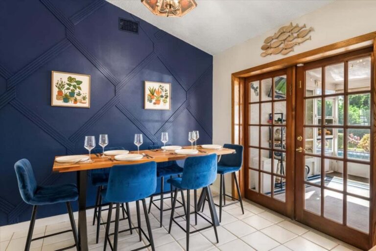 Dining table with blue chairs at Tortuga Hideaway